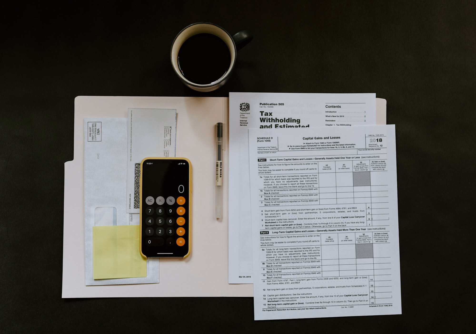 Financial records and calculator arranged on a desk
